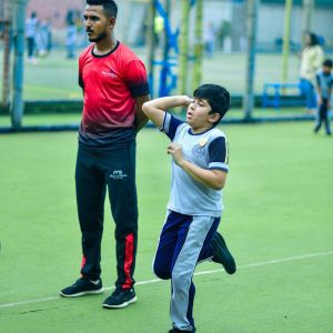Panbai International School student receiving focused cricket bowling coaching, refining technique and form for improved athletic performance