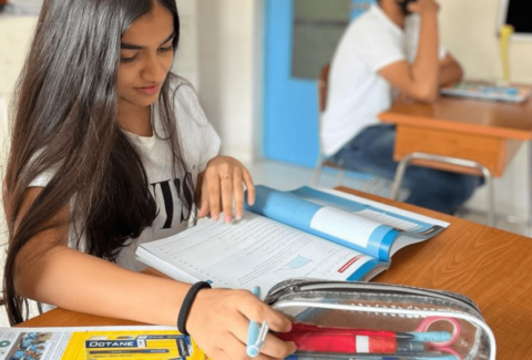 A level student of Panbai International school student studying in class room with Cambridge books