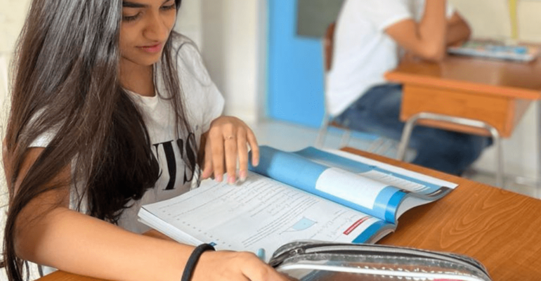 A level student of Panbai International school student studying in class room with Cambridge books