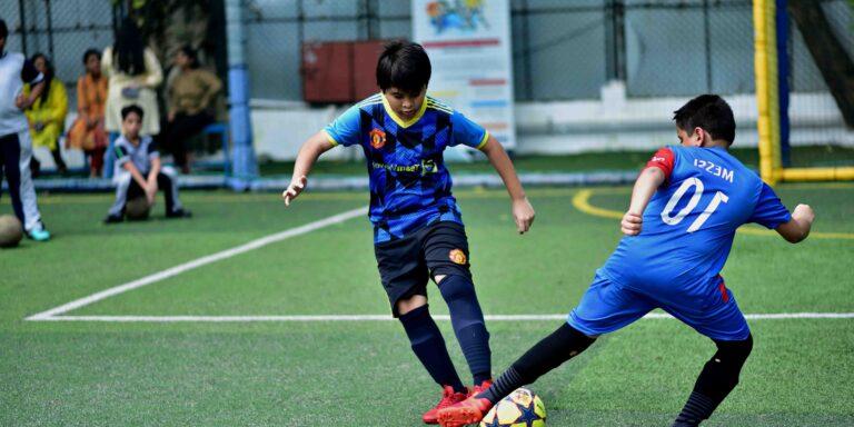 two-boys-football-coaching-Barca-academy-blue-jersey-panbai-international-school