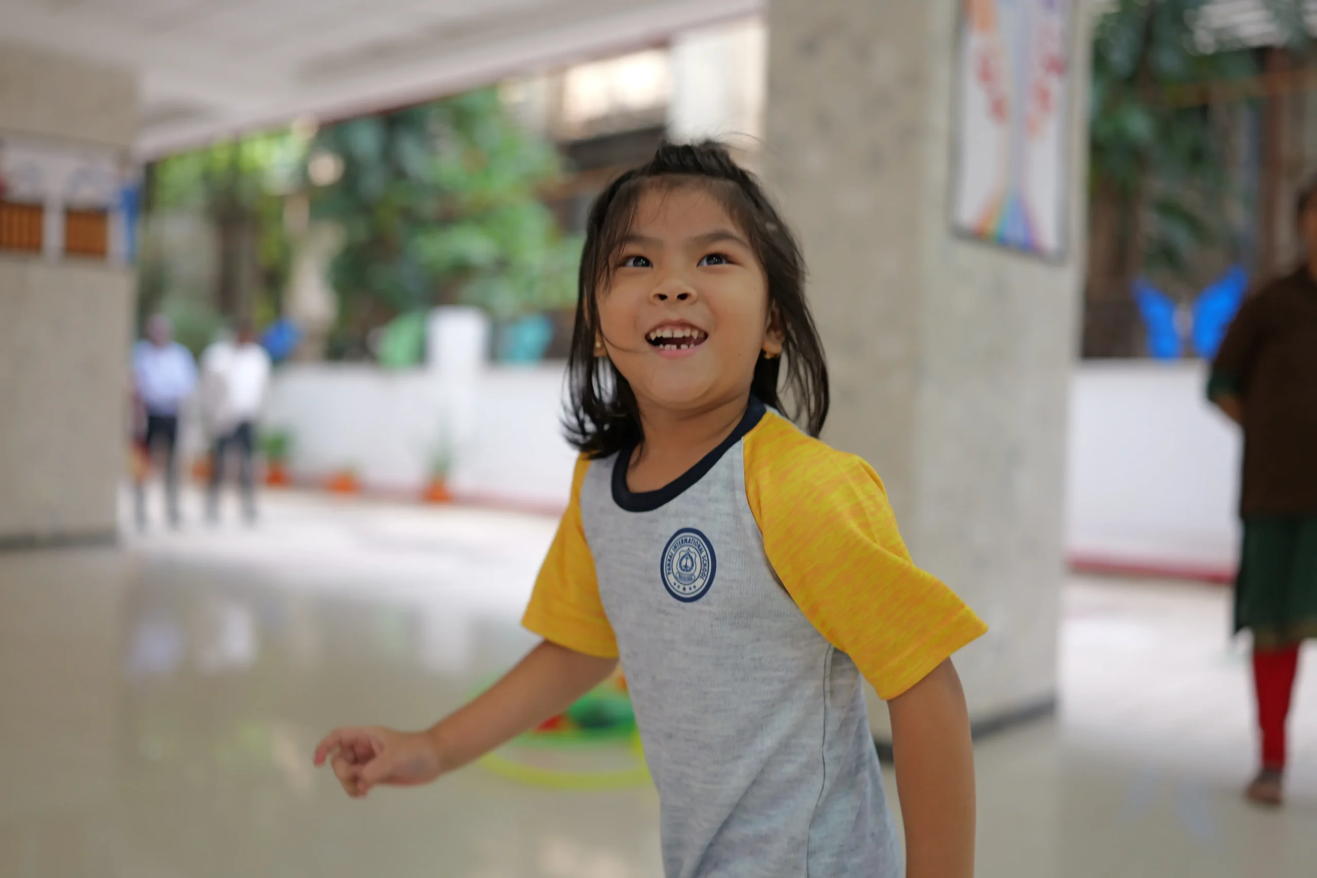 Smiling young child in Panbai International School uniform enjoying school activities, representing Playgroup and Nursery admissions open for AY 2026–2027 in Mumbai.