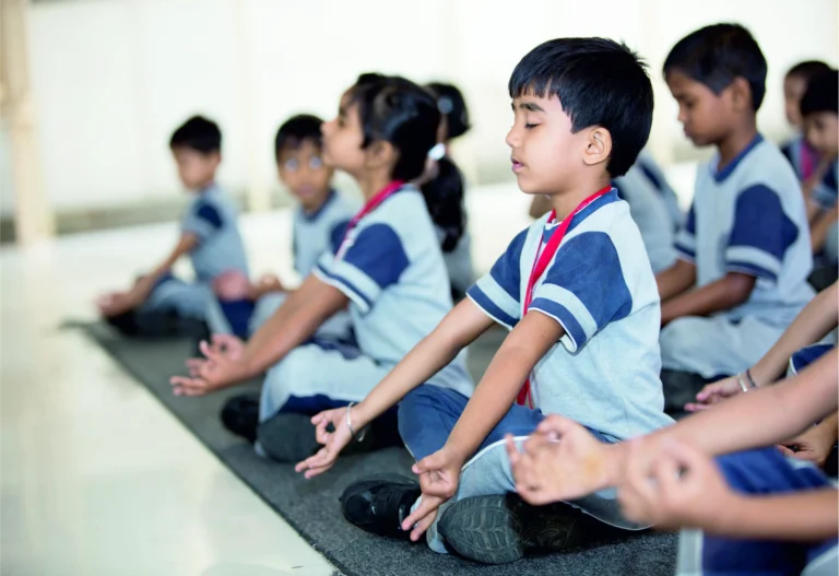 Students at Panbai International School practicing yoga and breathing exercises in a calm learning environment.