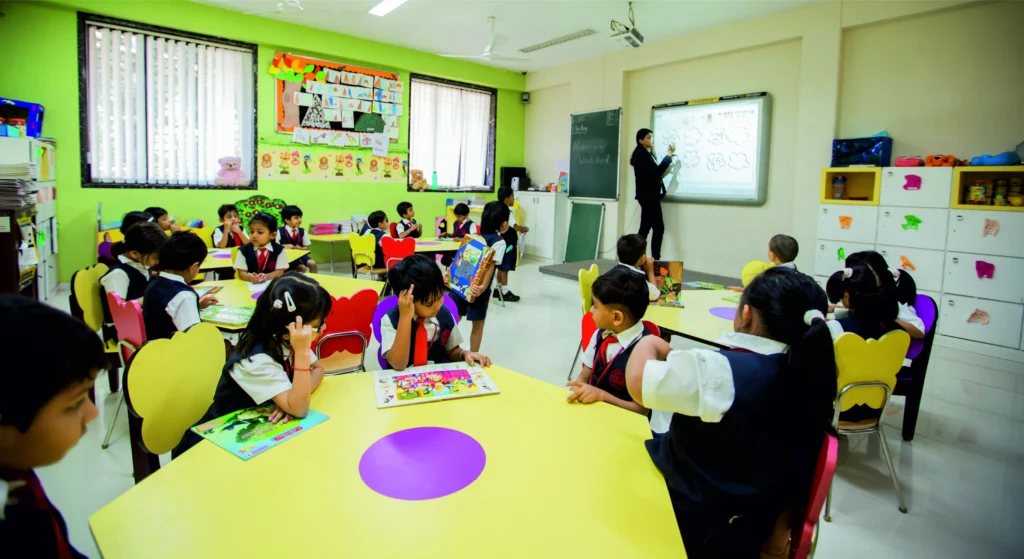 Nursery classroom with young children actively learning as the teacher guides them through fun activities.