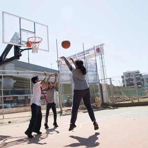 Students participating in basketball coaching as a co-curricular activity