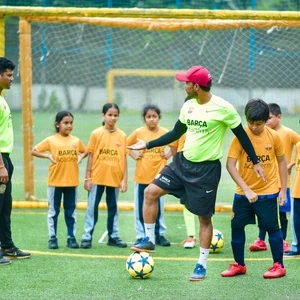 Students receiving football coaching as a co-curricular activity